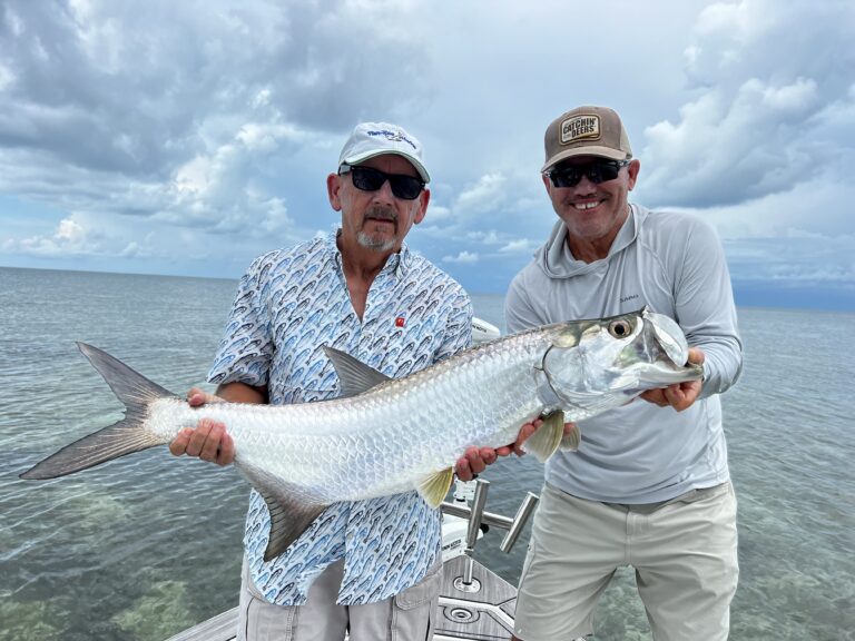 Two People Holding Big Fish