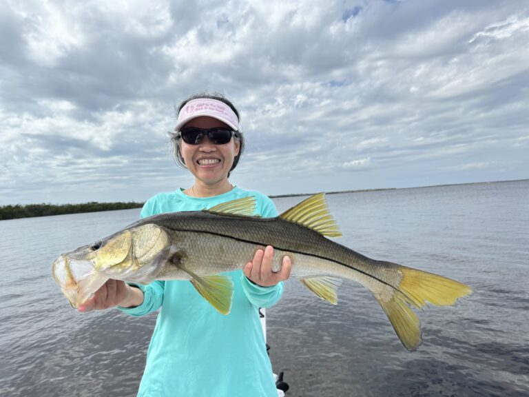 Happy Woman Holding Fish