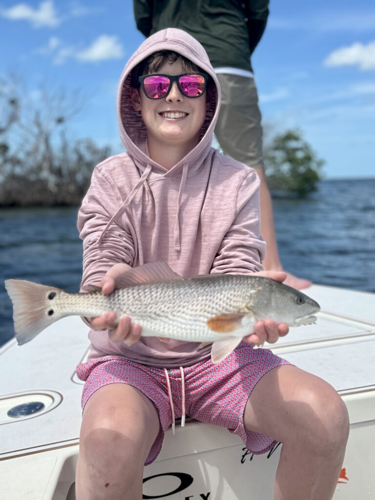 Happy Woman Holding Caught Fish