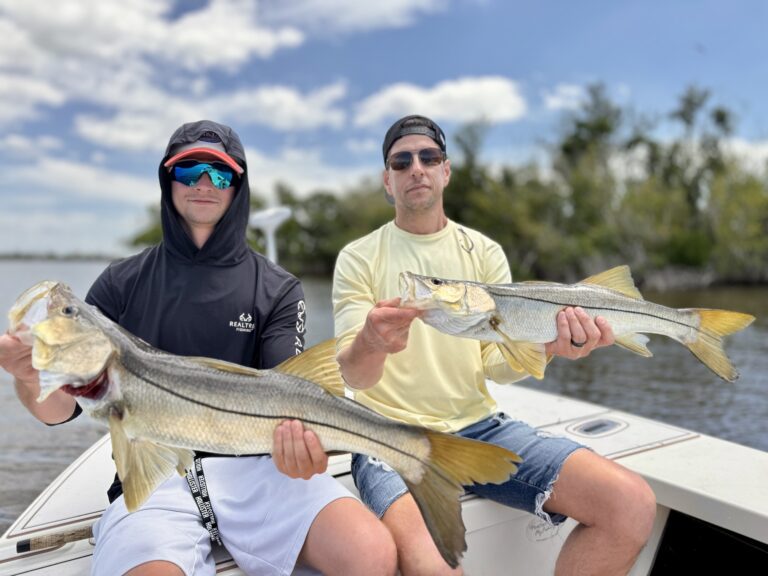Two Men Holding Fish