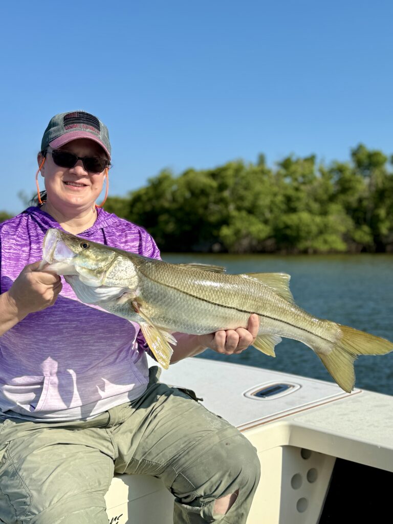 Woman Holding Caught Fish